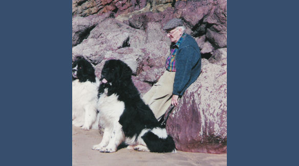 Brian with dogs by the rocks